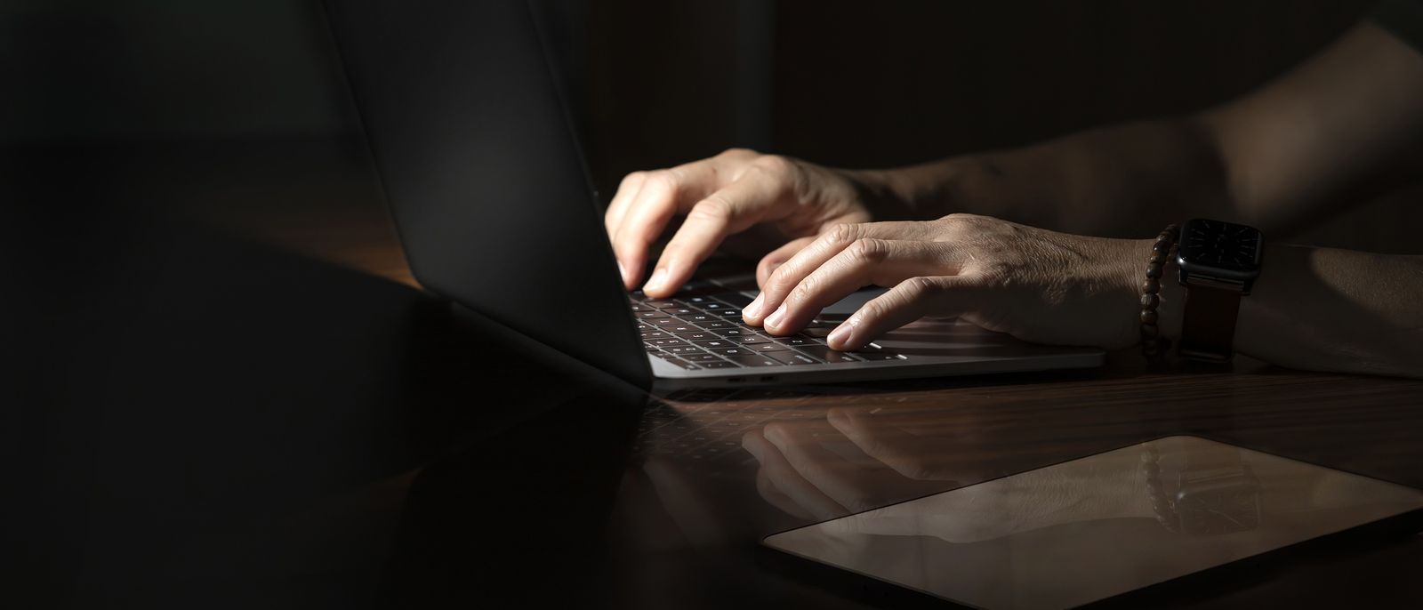 Hands writing at a keyboard